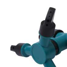 Insert a large three-head sprinkler. Automatic 360 degree rotating lawn sprinkler. Nozzle. Tandem pin nozzle
