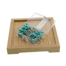 100 pearlescent needles in a colored plastic box. Paper positioning needle. Garment pin. Round pin.