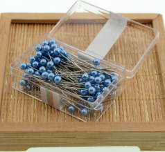 100 pearlescent needles in a colored plastic box. Paper positioning needle. Garment pin. Round pin.