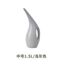 Long mouth watering pot. Domestic indoor garden watering pot for flowers and vegetables. Watering can and watering can