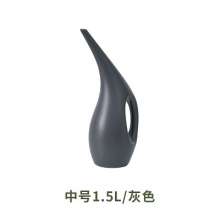 Long mouth watering pot. Domestic indoor garden watering pot for flowers and vegetables. Watering can and watering can